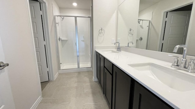 4219 Sky Dr, Sherman, TX 75090 - bathroom featuring a shower stall, double vanity, baseboards, and recessed lighting