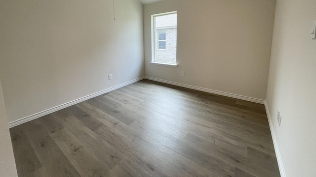 4219 Sky Dr, Sherman, TX 75090 - empty room with wood finished floors and baseboards