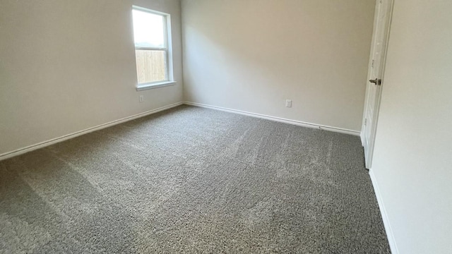 4219 Sky Dr, Sherman, TX 75090 - empty room featuring dark carpet and baseboards