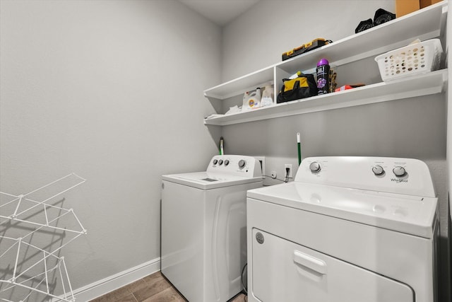 laundry room featuring washing machine and dryer and hardwood / wood-style flooring