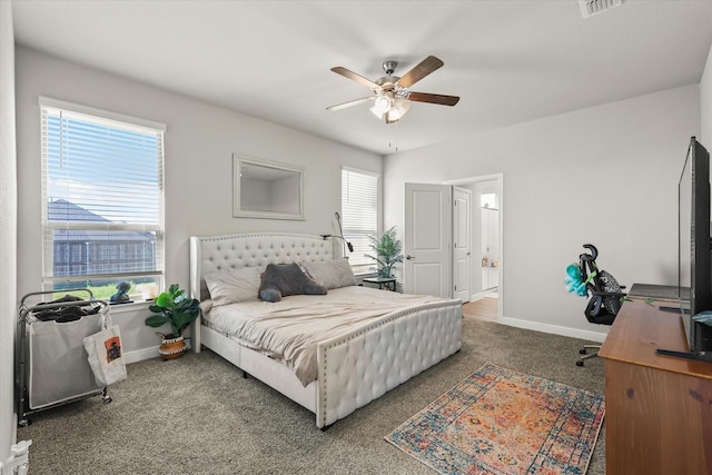 carpeted bedroom featuring ceiling fan and multiple windows