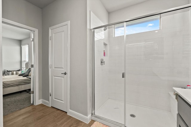 bathroom featuring vanity and a shower with door