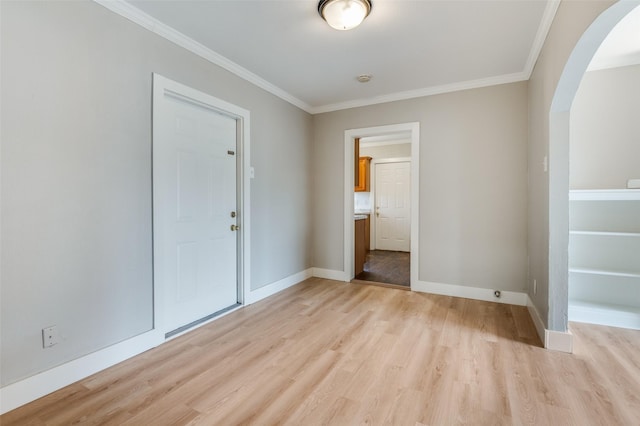 interior space featuring light wood-type flooring and ornamental molding