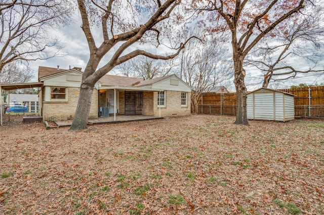 back of house with central AC unit, a patio area, and a storage unit