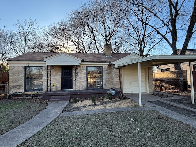 view of front facade with a garage and a carport