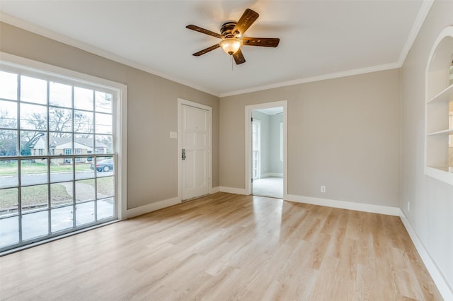 empty room with ceiling fan, ornamental molding, and light wood-type flooring