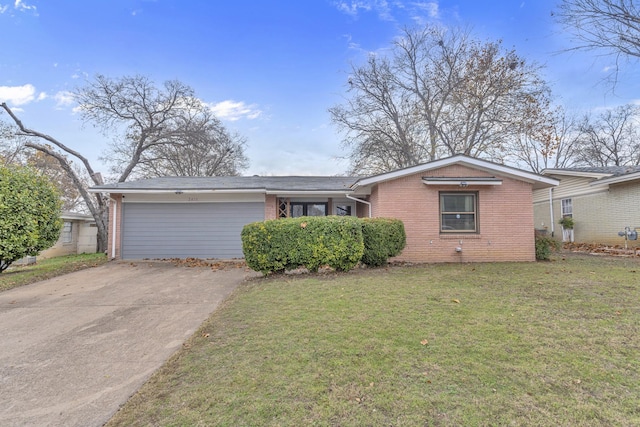 ranch-style house with a garage and a front yard