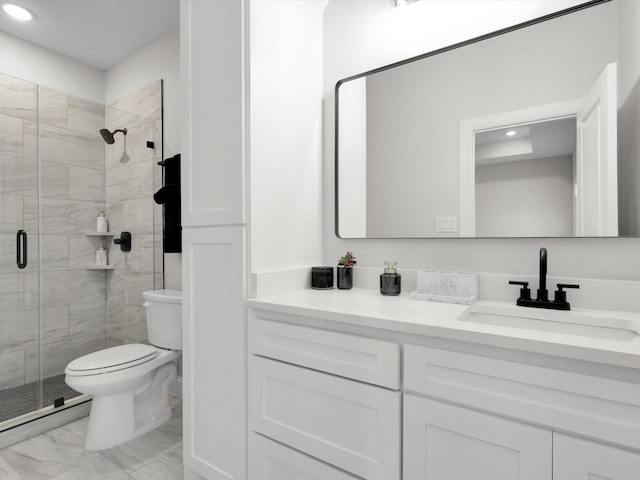 bathroom featuring vanity, an enclosed shower, and toilet