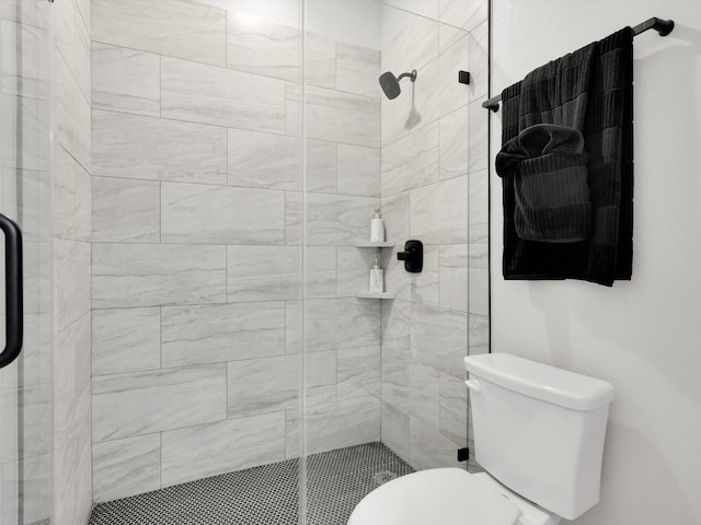 bathroom featuring an enclosed shower and toilet