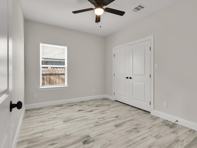 unfurnished bedroom with a closet, ceiling fan, and light hardwood / wood-style flooring