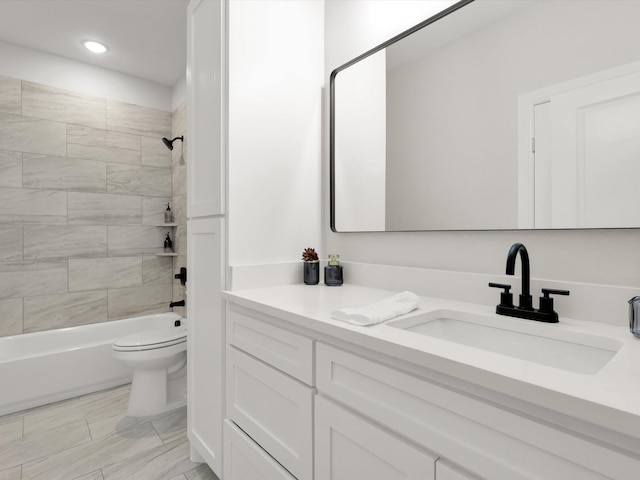 full bathroom with tiled shower / bath combo, vanity, and toilet