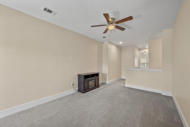 unfurnished living room featuring ceiling fan and light carpet