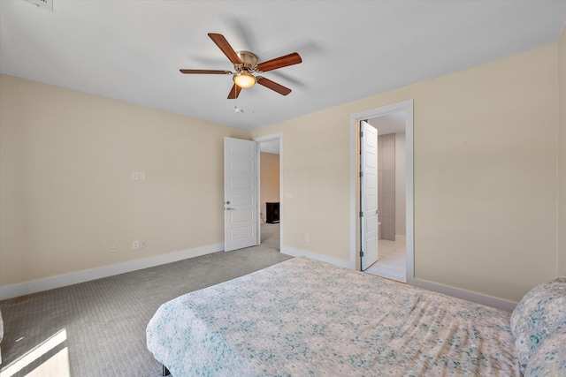 bedroom with connected bathroom, ceiling fan, and light carpet