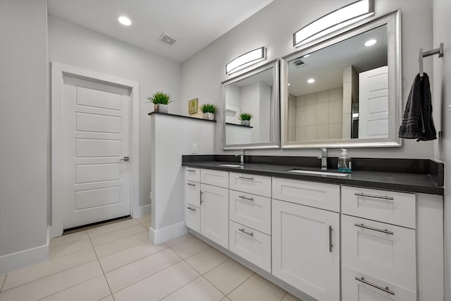 bathroom featuring tile patterned flooring and vanity