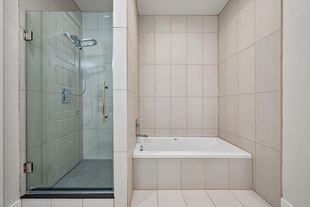 bathroom with tile patterned floors, separate shower and tub, and tile walls