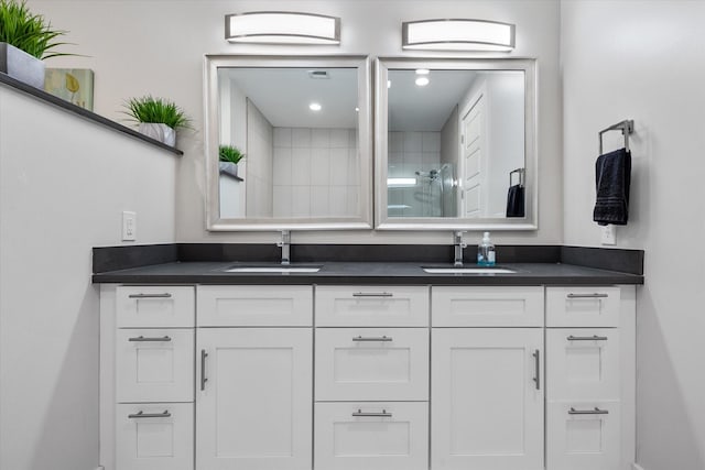 bathroom featuring vanity and tiled shower