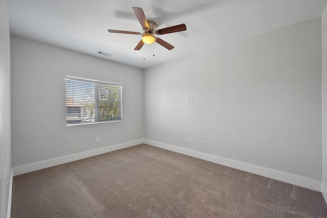 carpeted empty room featuring ceiling fan