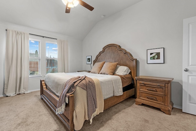 carpeted bedroom with ceiling fan and vaulted ceiling