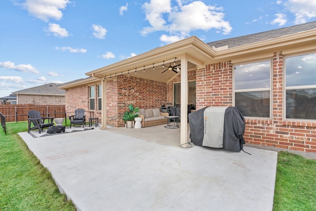 view of patio featuring ceiling fan, a grill, and an outdoor living space