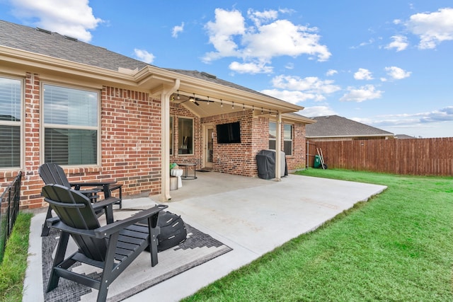 rear view of house with a yard and a patio