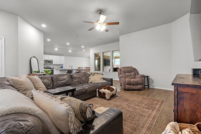 living room with ceiling fan and hardwood / wood-style flooring