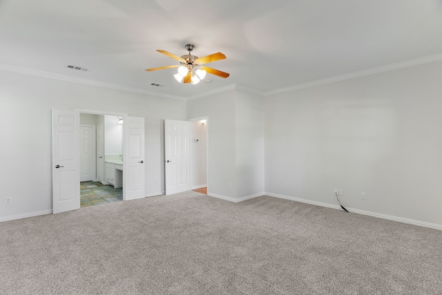 unfurnished bedroom with ensuite bathroom, ceiling fan, crown molding, and light carpet