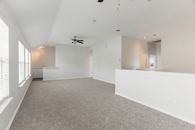 carpeted empty room with lofted ceiling and ceiling fan