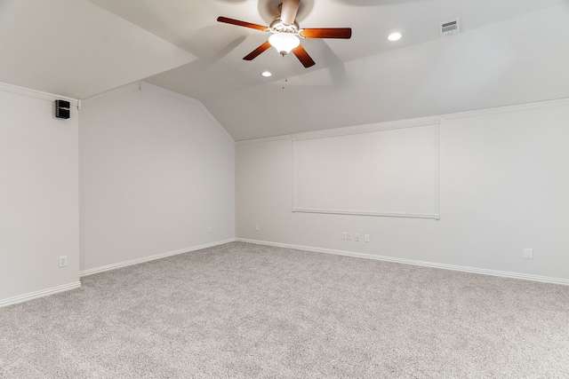 additional living space with carpet floors, ceiling fan, and vaulted ceiling