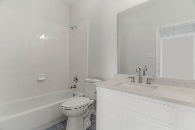 full bathroom with tile patterned flooring, toilet, vanity, and tiled shower / bath