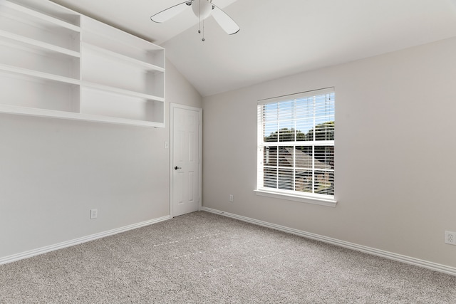 carpeted spare room with lofted ceiling and ceiling fan