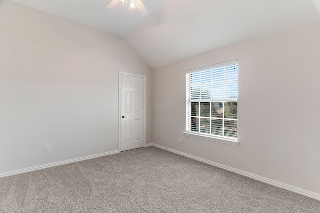 carpeted empty room with lofted ceiling and ceiling fan