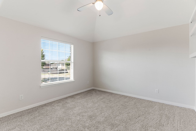 unfurnished room featuring ceiling fan, lofted ceiling, and carpet