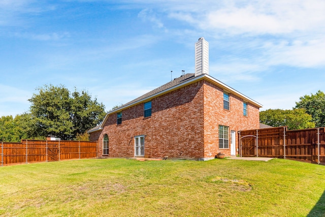 back of house featuring a yard