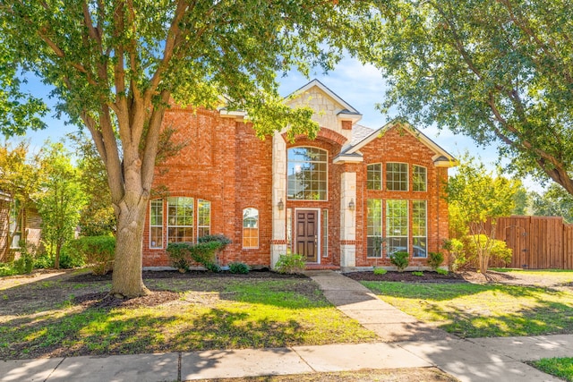 view of property featuring a front lawn