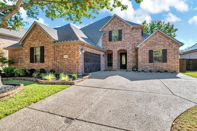 front of property with a front yard and a garage