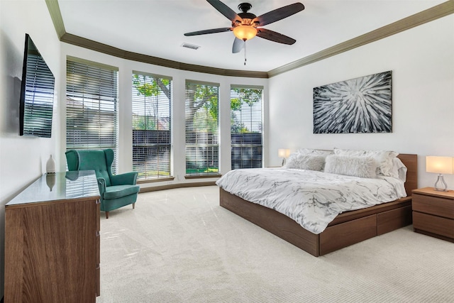 bedroom featuring light carpet, ornamental molding, and ceiling fan