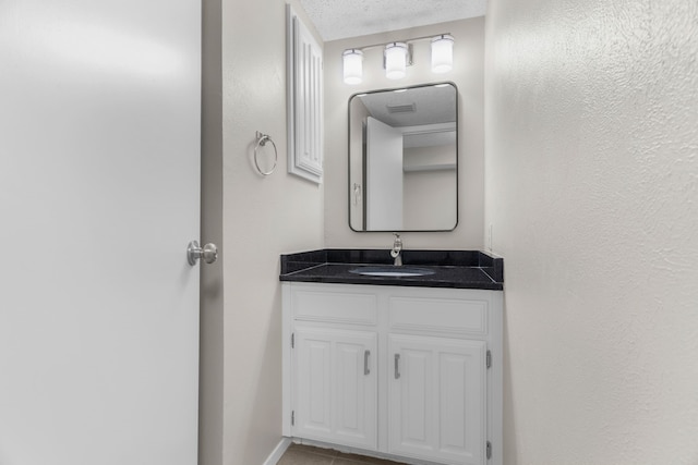 bathroom featuring vanity and a textured ceiling