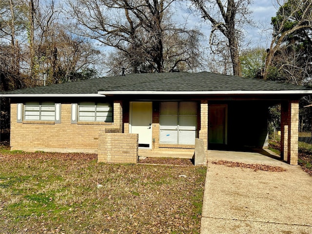 view of front of property with a front lawn and a carport