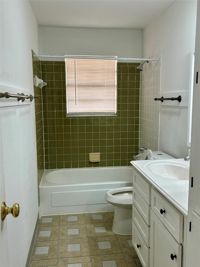 full bathroom with toilet, vanity, and tiled shower / bath combo