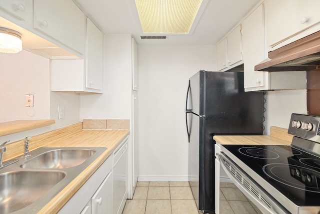 kitchen featuring dishwasher, sink, light tile patterned floors, stainless steel electric range, and white cabinets