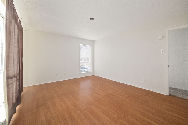 empty room featuring hardwood / wood-style floors and a textured ceiling