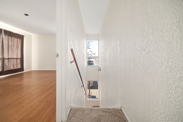 staircase with heating unit and hardwood / wood-style floors