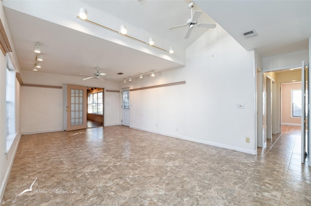 spare room with ceiling fan, french doors, and a healthy amount of sunlight