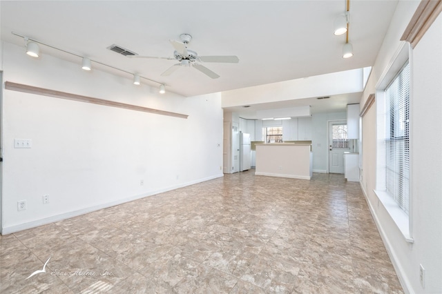 unfurnished living room with ceiling fan