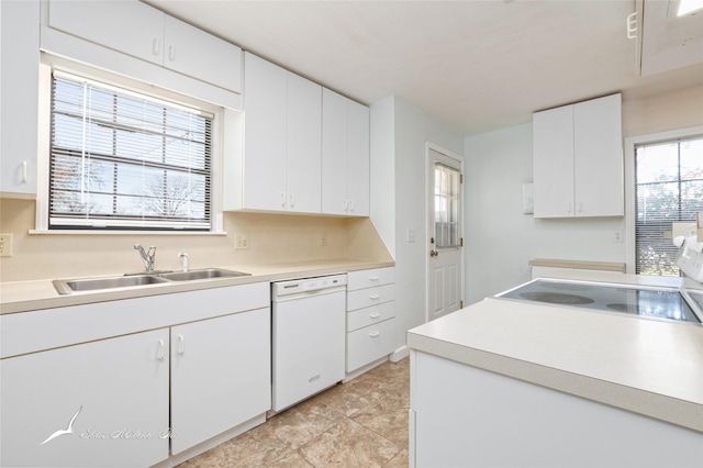 kitchen featuring dishwasher, white cabinetry, sink, and range