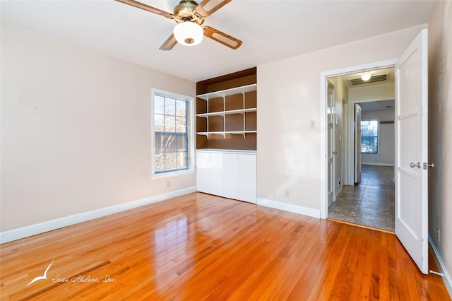 spare room with hardwood / wood-style floors and ceiling fan