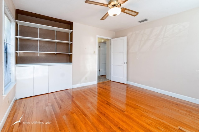 unfurnished bedroom with ceiling fan, light wood-type flooring, and a closet