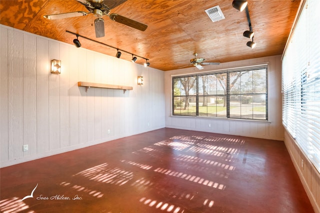 empty room with wooden walls, ceiling fan, and wooden ceiling