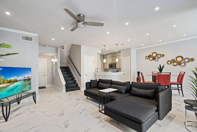 living room featuring crown molding and ceiling fan