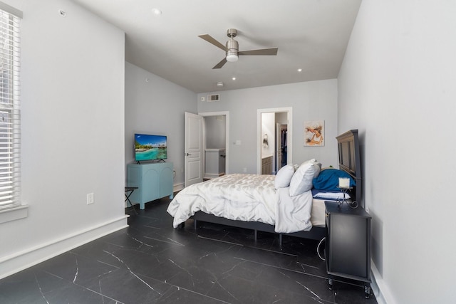 bedroom with multiple windows, ceiling fan, and ensuite bath